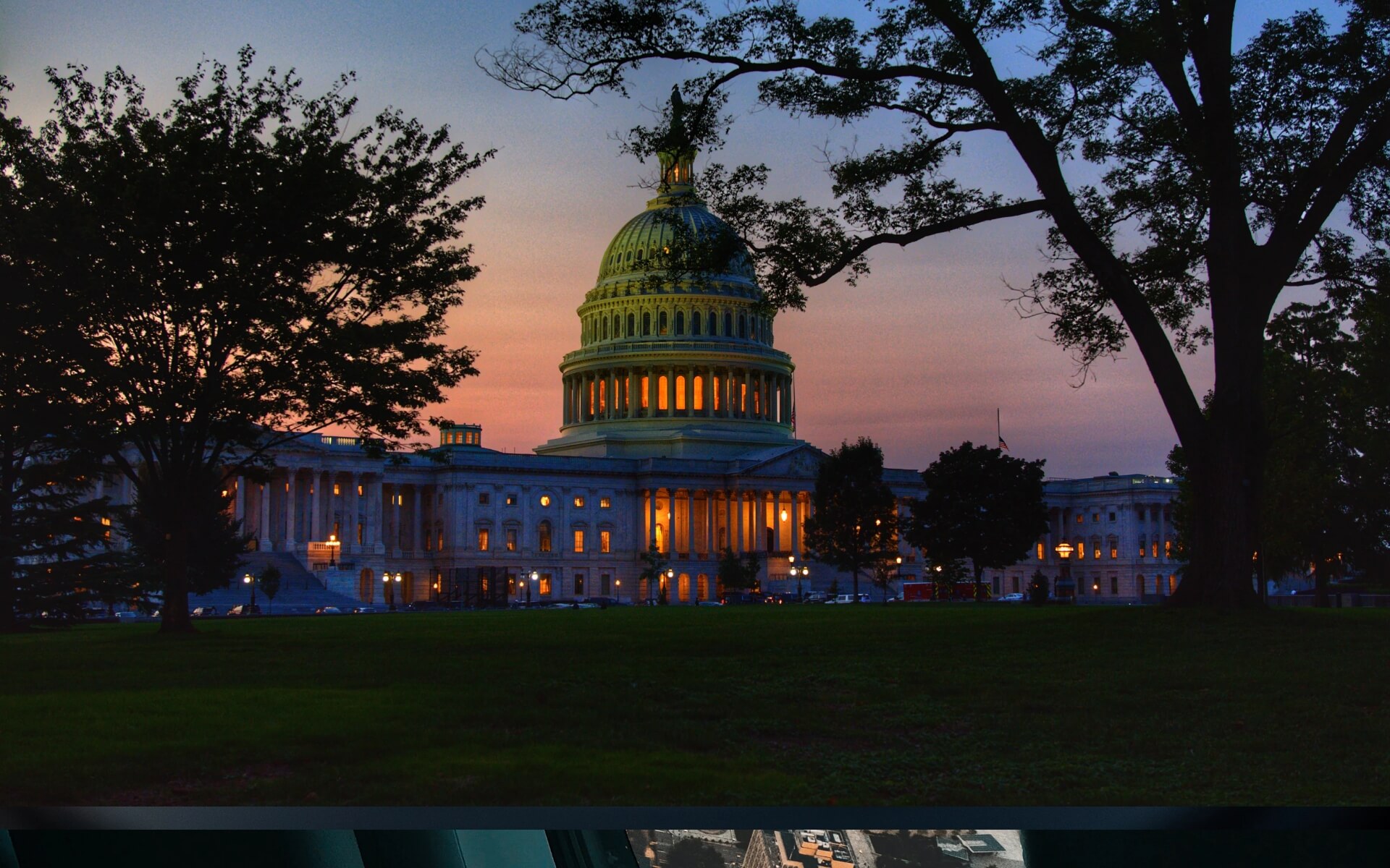 The United States Capitol at dusk, illuminated from within,