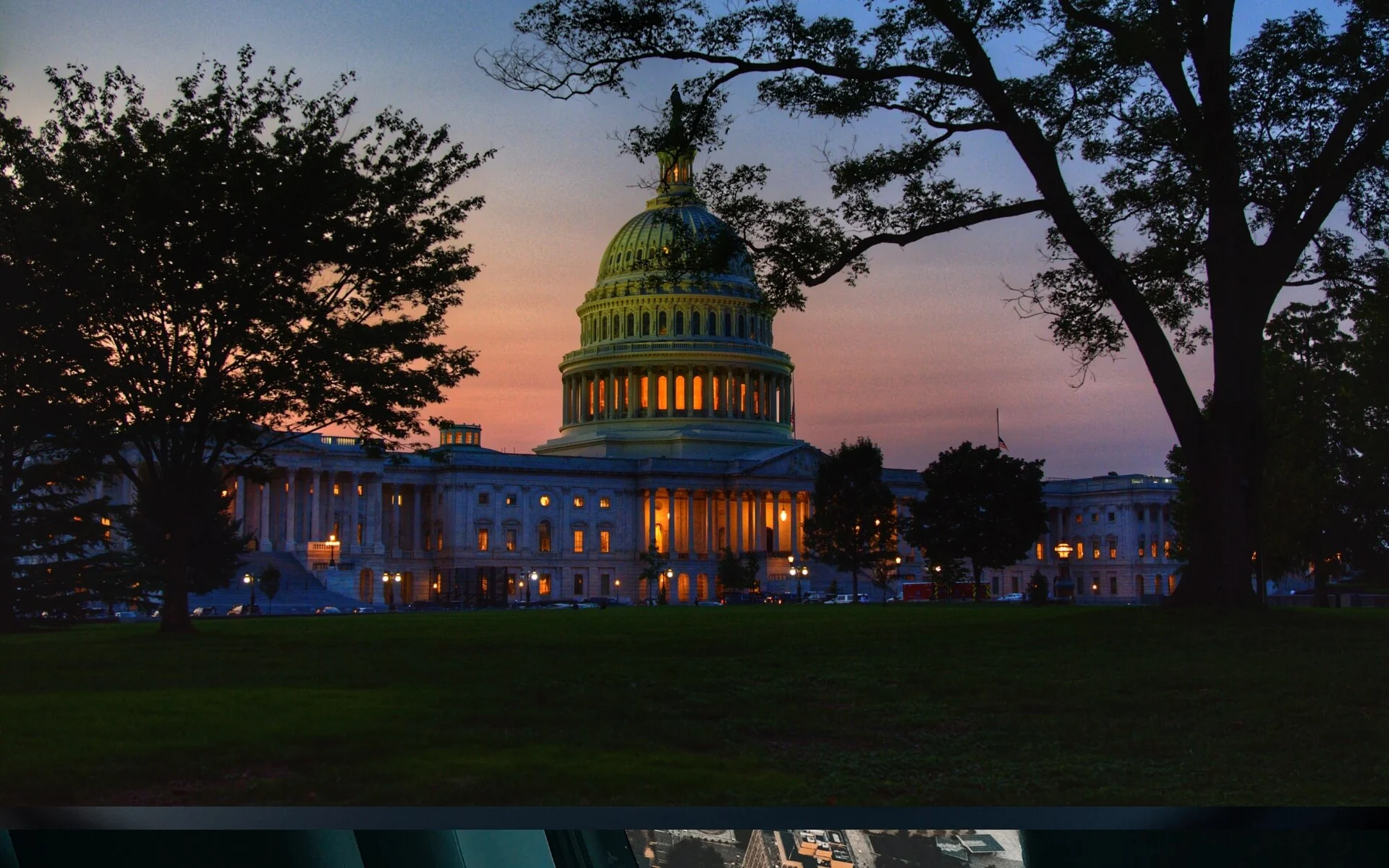 The United States Capitol at dusk, illuminated from within,
