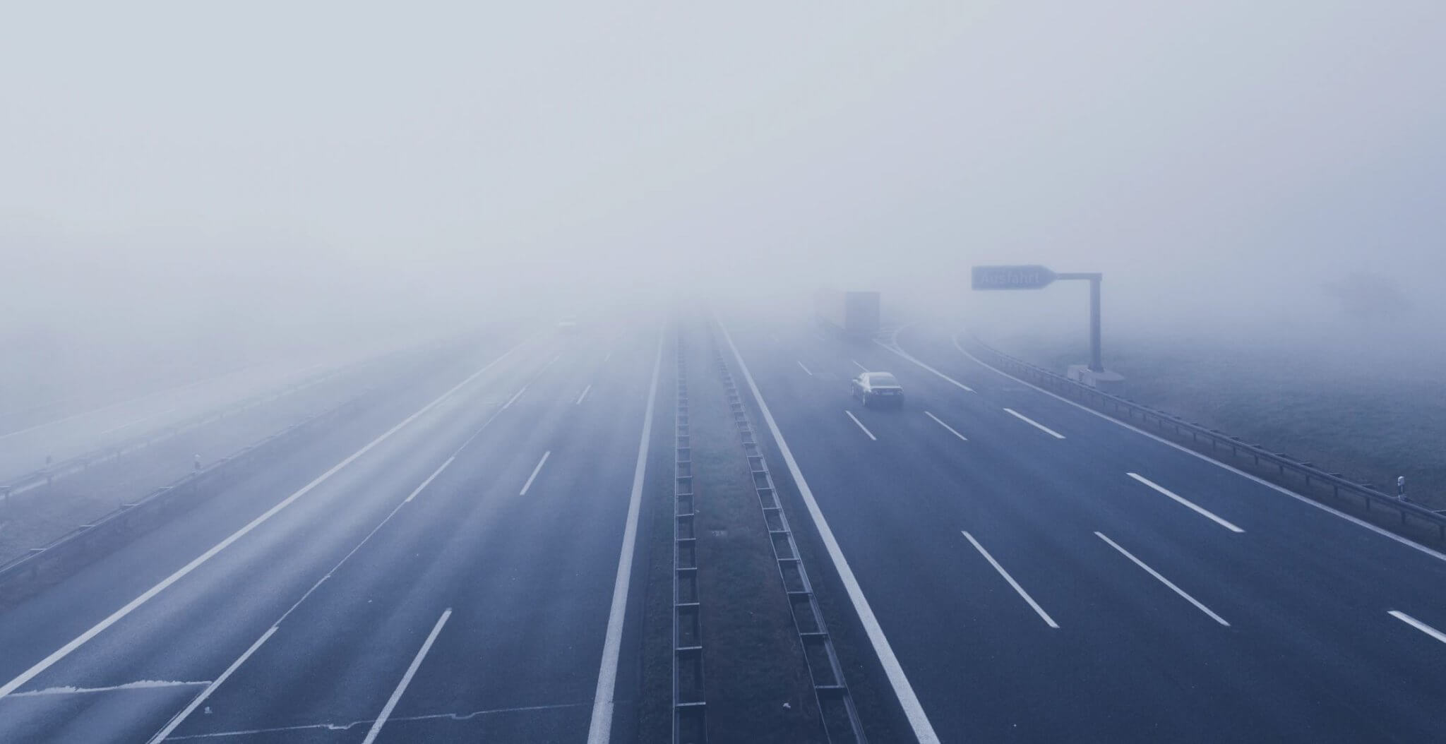 An interstate highway shrouded in fog.