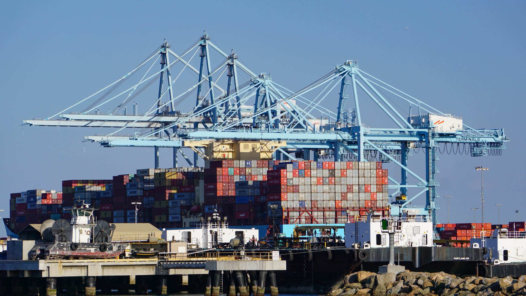 Photo os cranes and shipping containers at the Port of LA.