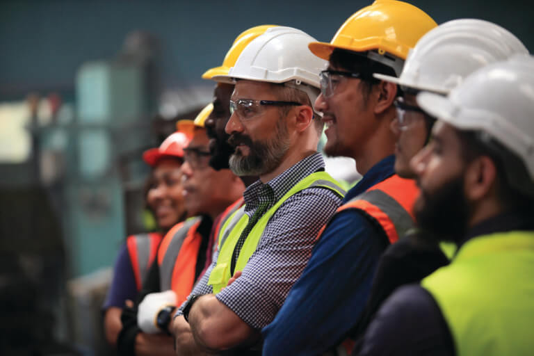 Candid photo of a group of engineers smiling.