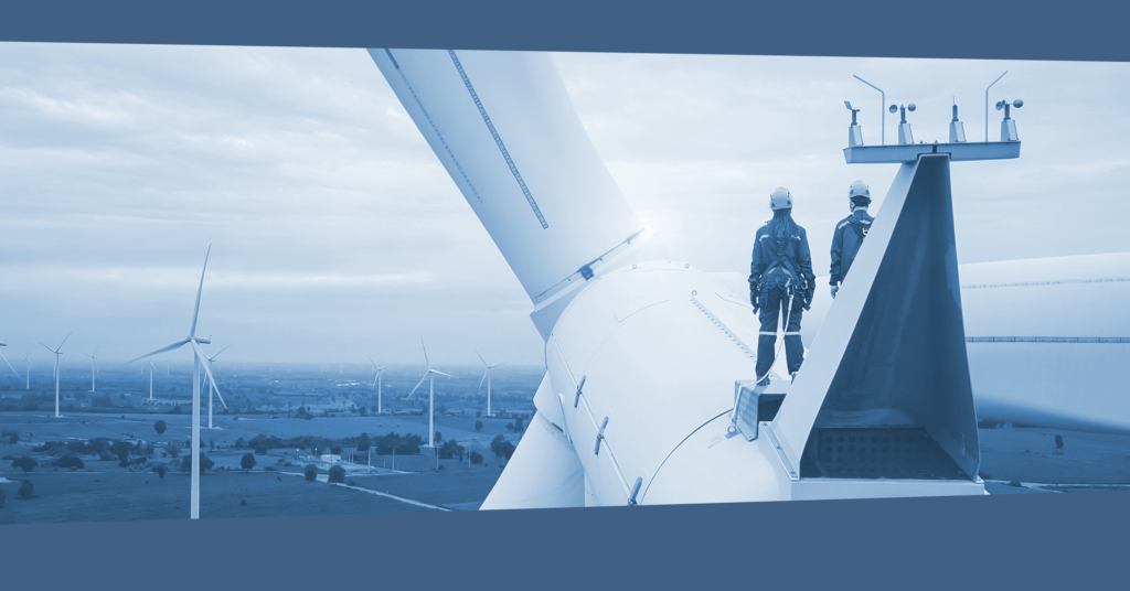 Promotional banner of two wind technicians standing on top of a wind turbine looking out over a field in blue.