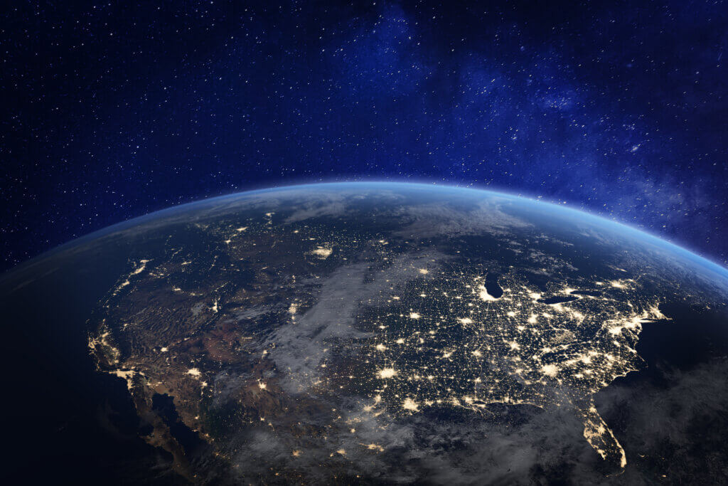 North America at night viewed from space with city lights showing human activity in United States.