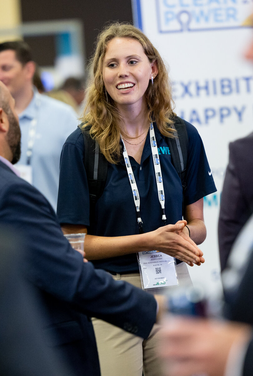 An ACP conference attendee wears a lanyard - sponsorship opportunity.