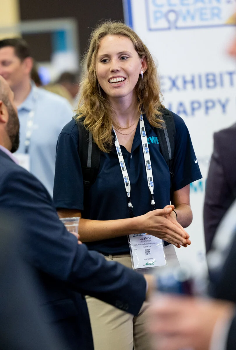 An ACP conference attendee wears a lanyard - sponsorship opportunity.