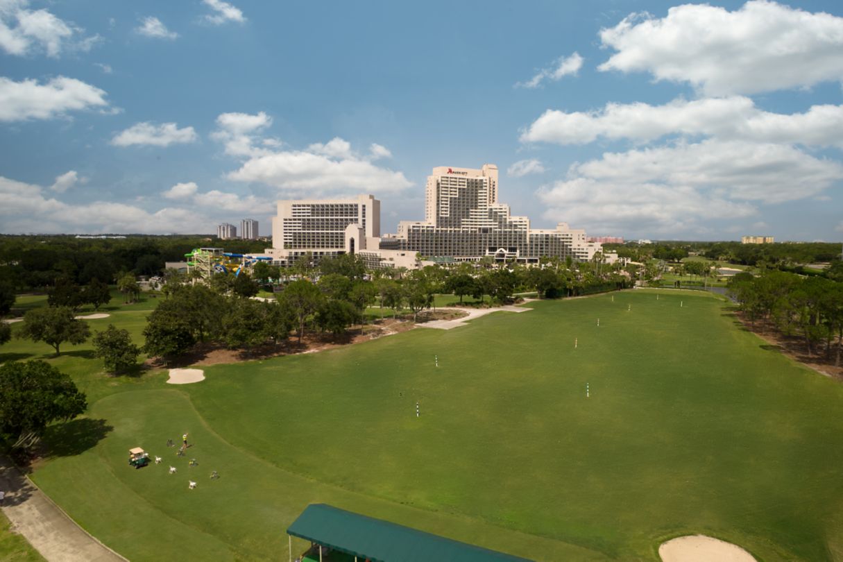 A Marriot hotel with a golf course in the foreground.