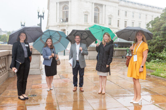ACP Members Smile in the Rain Outside the Capitol.