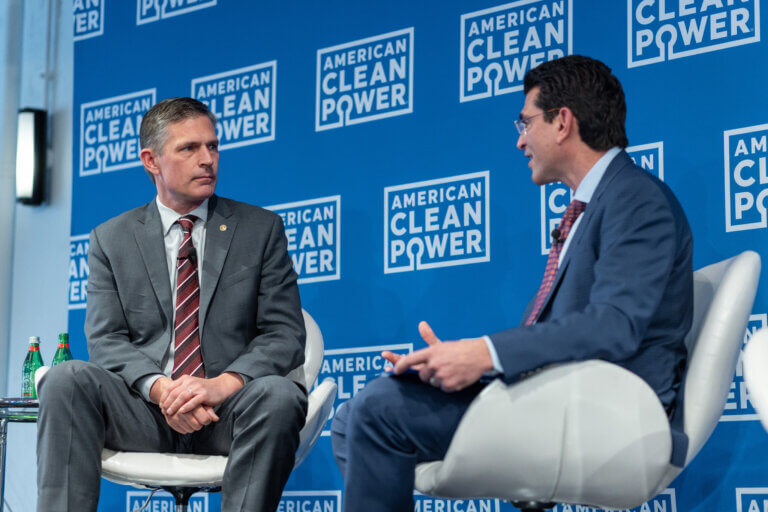 ACP CEO Jason Grumet Speaks with a Panelist at a Conference.