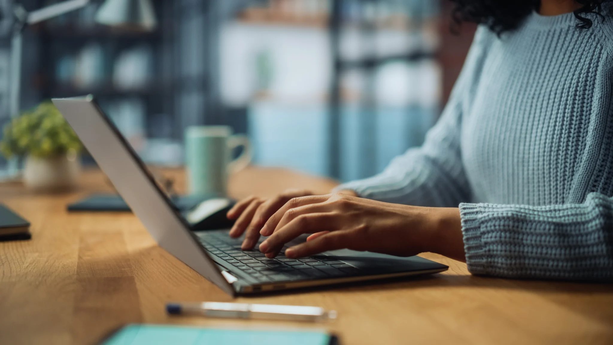 Close Up on Hands of a Female Specialist Working on Laptop Computer.