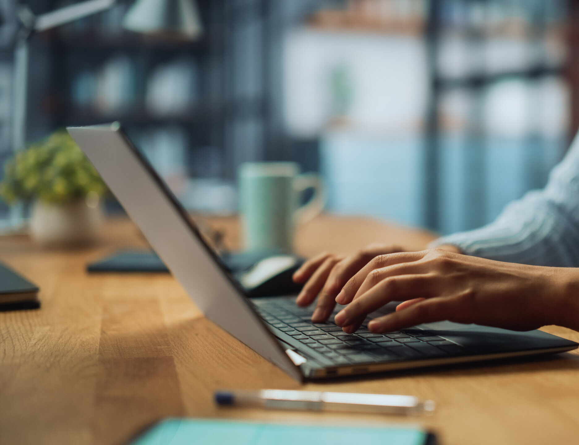 Close Up on Hands of a Female Specialist Working on Laptop Computer.