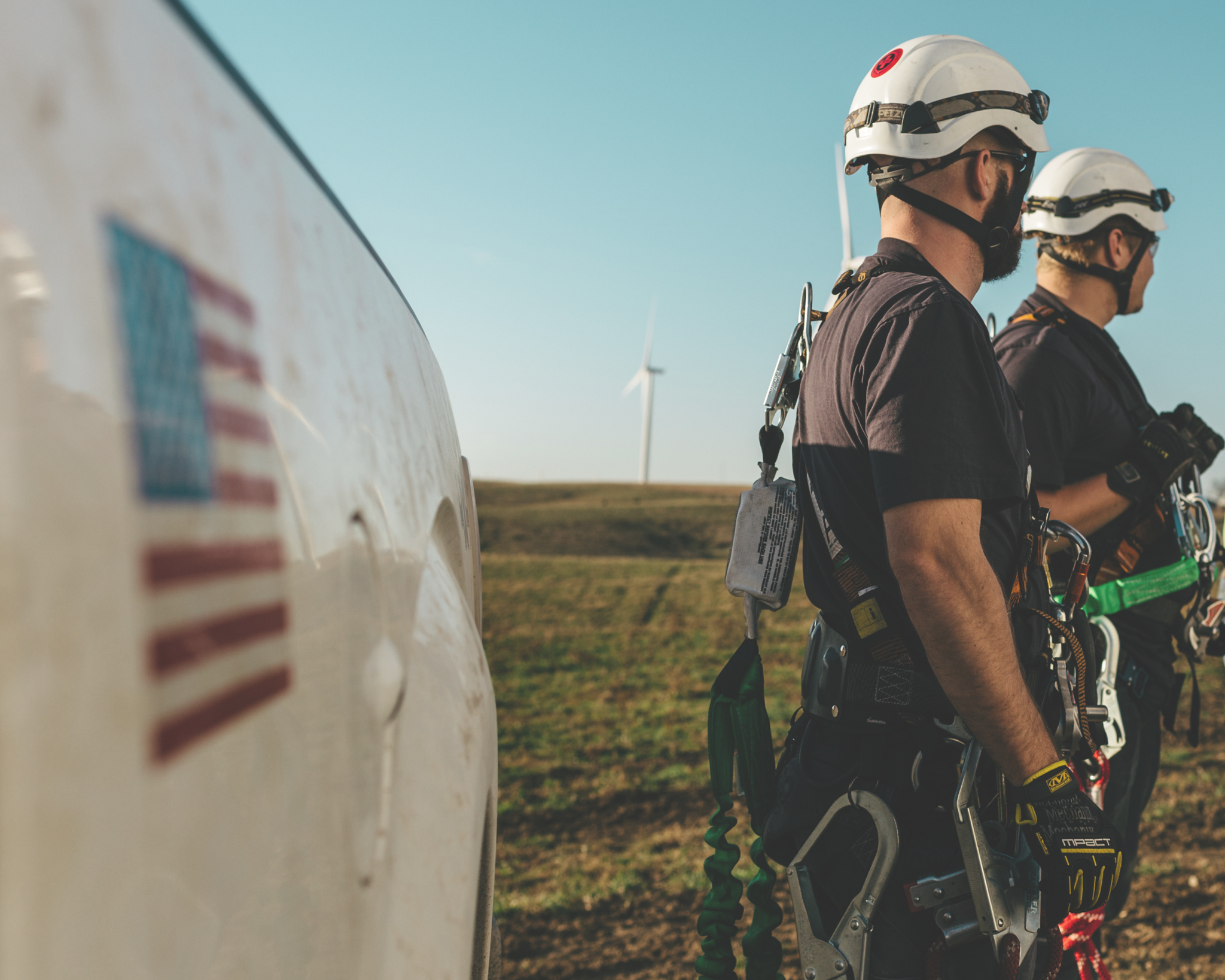 Two Wind Turbine Technicians Outfitted with Service Equipment.