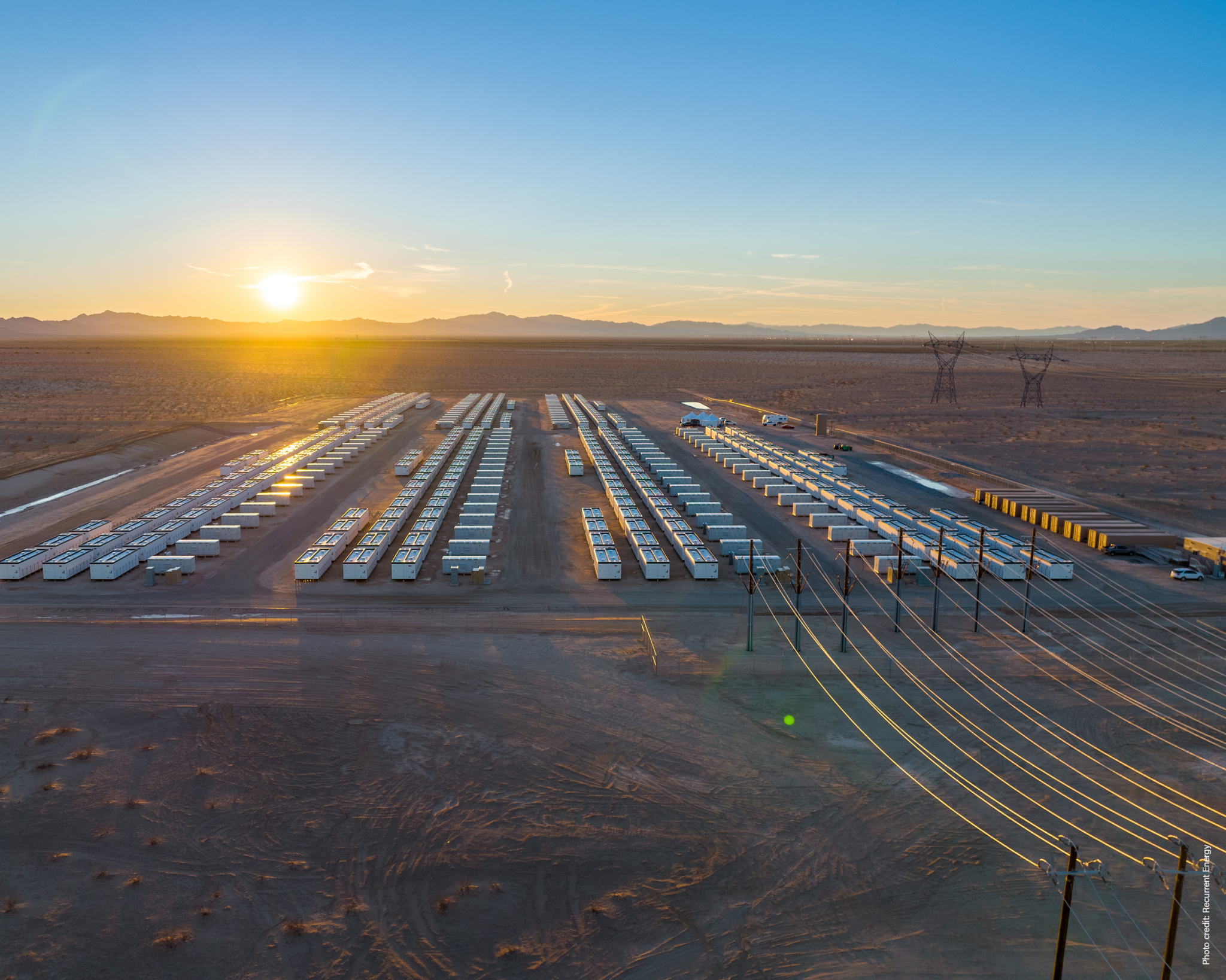 A Utility-Scale Battery Storage Facility and Transmission Lines in the Desert.