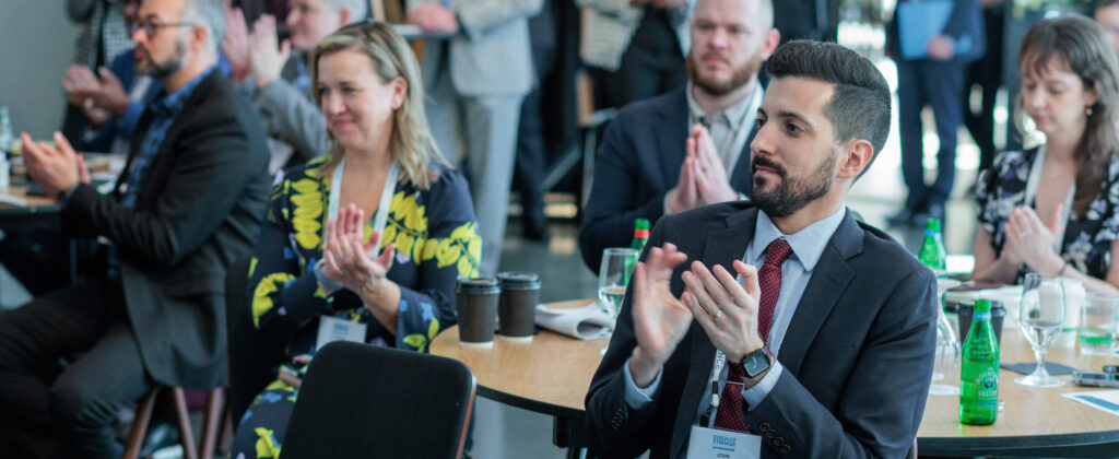 Attendees of an ACP Conference Clap.