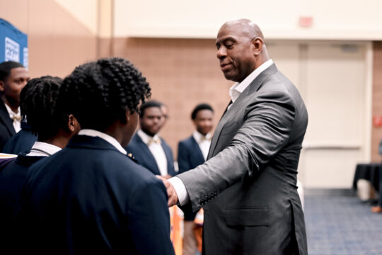 Magic Johnson backstage at ACP's CLEANPOWER Conference talking to local performing group The Royal Boys Choir.