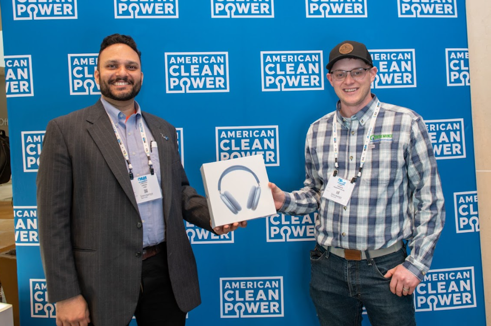 Winners of ACP's Guess Watt challenge at the Offshore Windpower conference showing their prize.