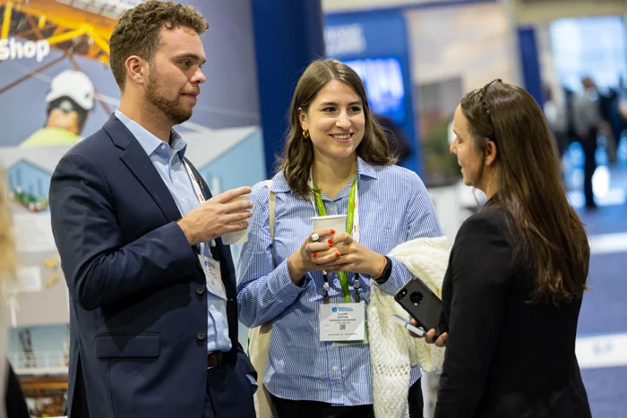 Attendees of an ACP conference networking and drinking coffee.