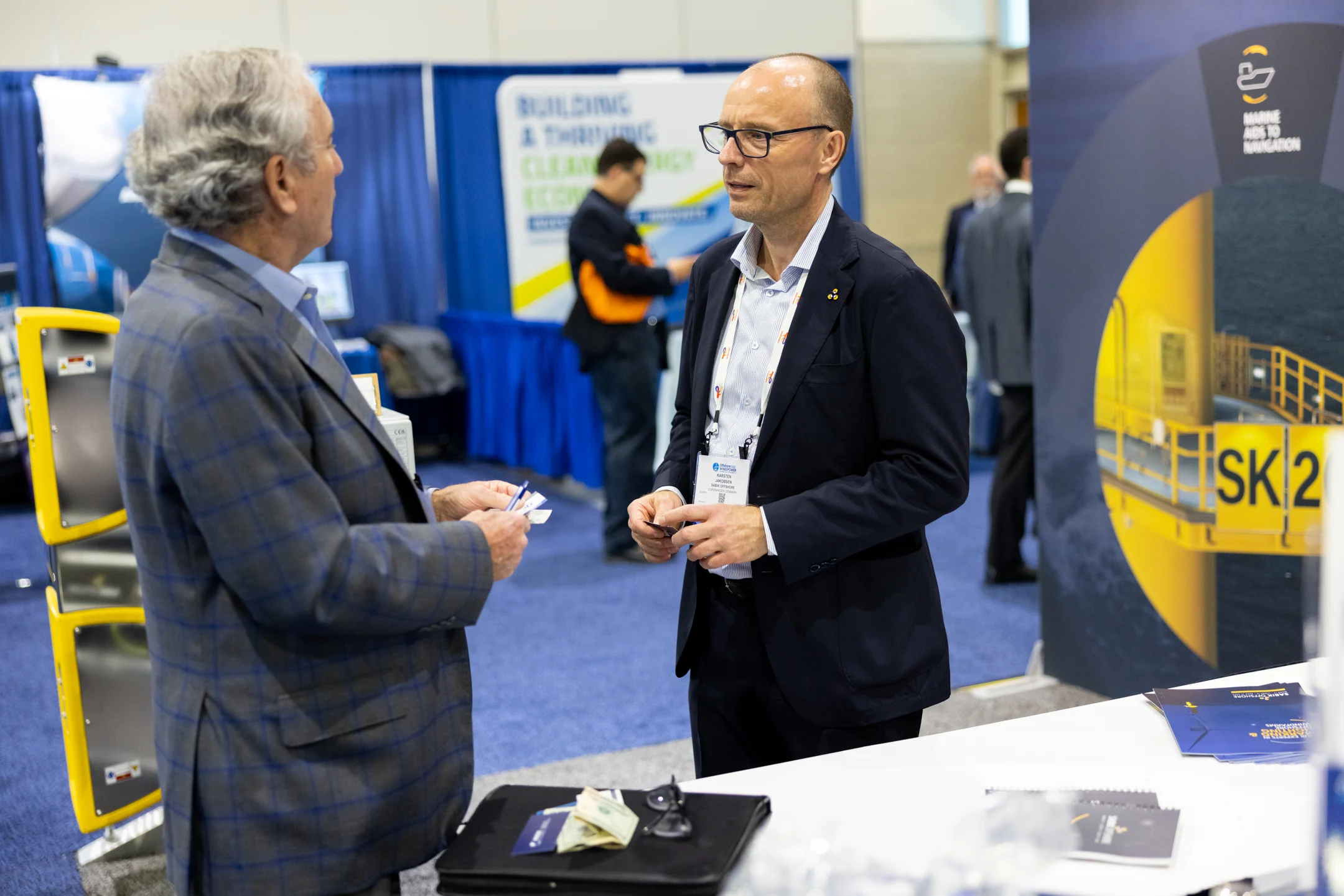 Two ACP conference attendees chatting on the exhibition floor.
