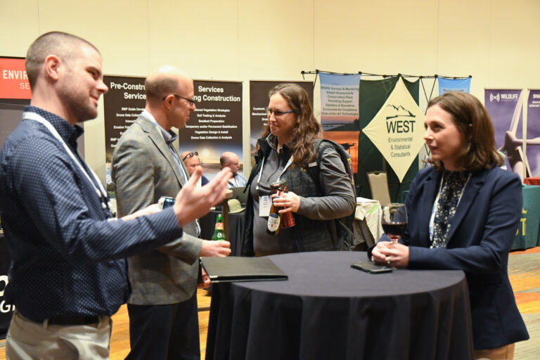A group of people networking in the exhibit hall at Siting 2023