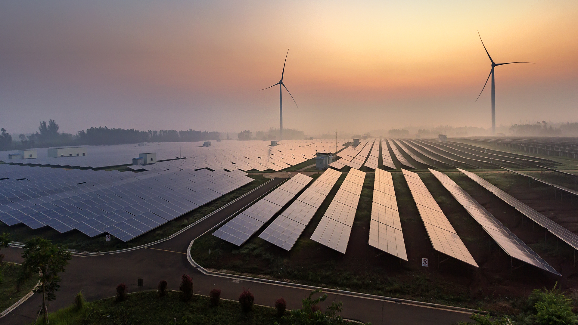 A field of various renewable energy technologies, including solar panels, battery storage, and wind energy.