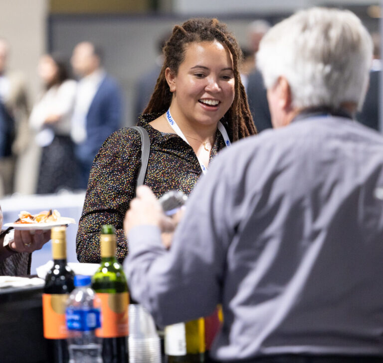 An attendee of an American Clean Power (ACP) conference enjoying a sponsored happy hour reception.