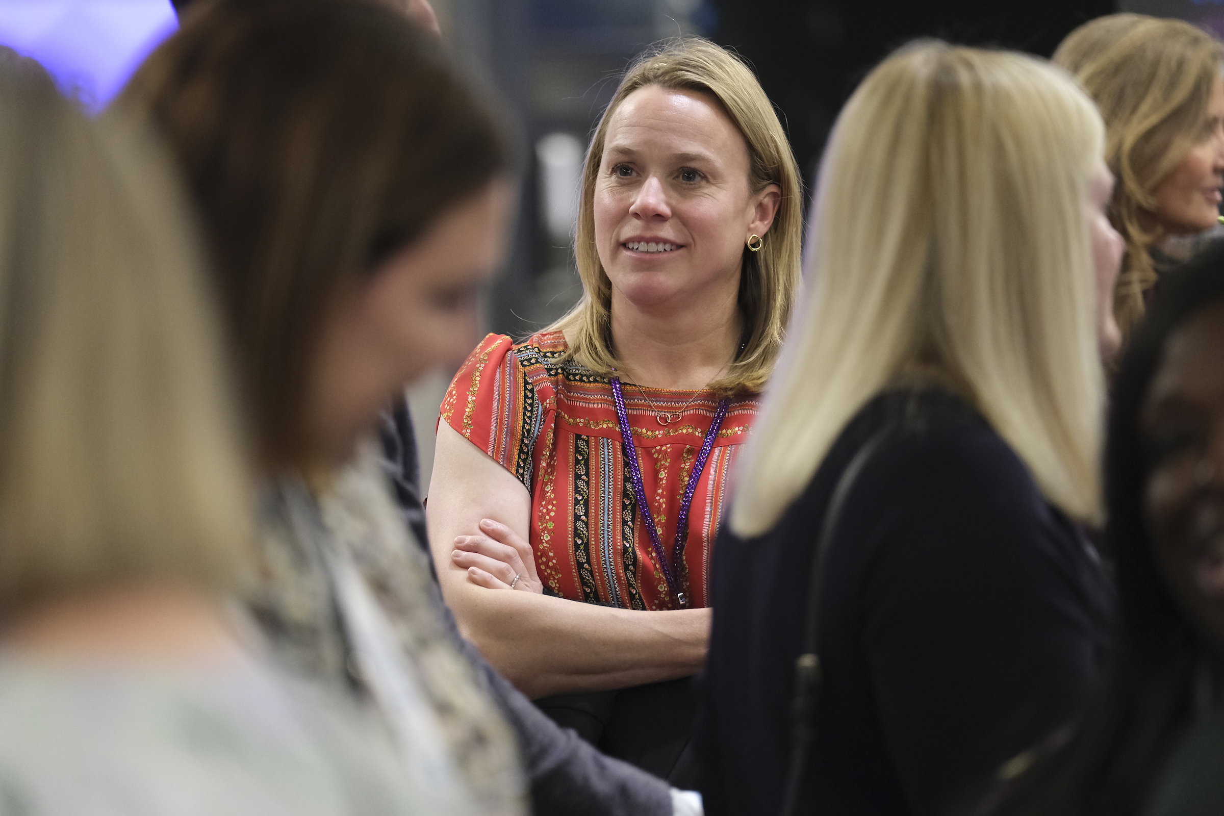 Woman smiling during group networking conversation