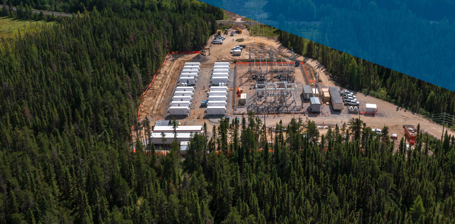 Birds-eye view of a storage and transmission project between evergreen trees.