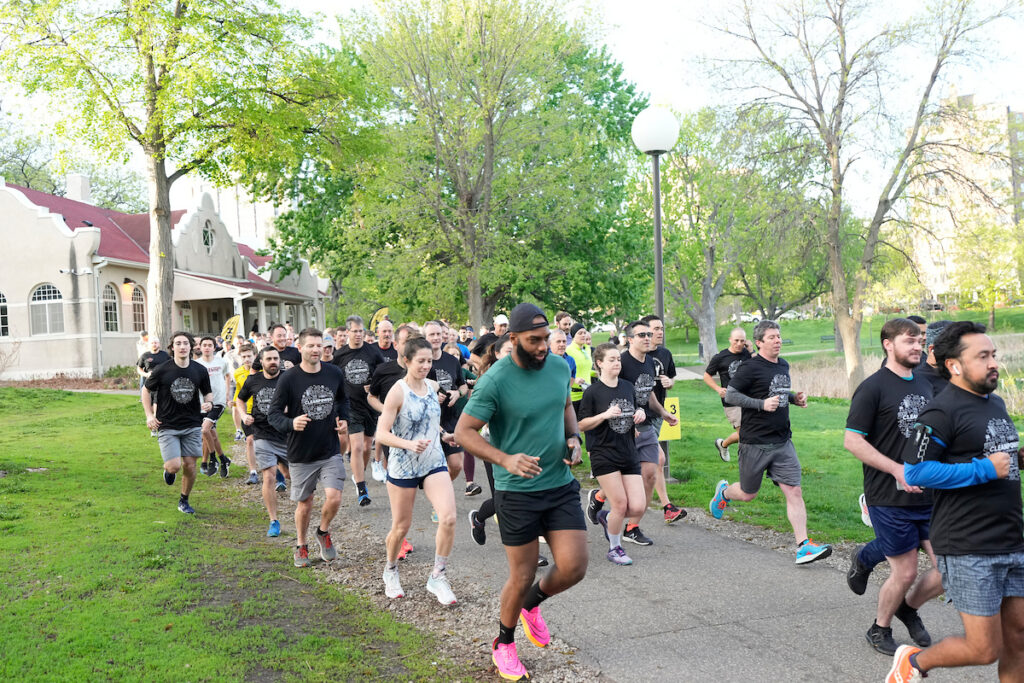 A large group of runners in a park at CLEANPOWER 2024