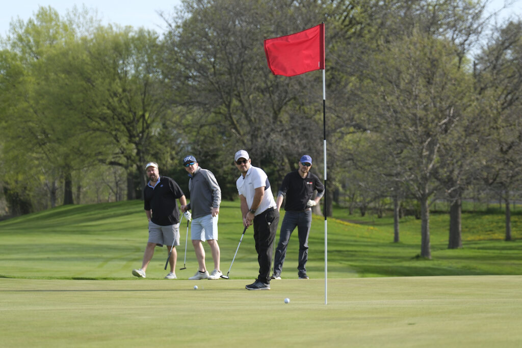 Four men playing in the CLEANPOWER 2024 golf tournament