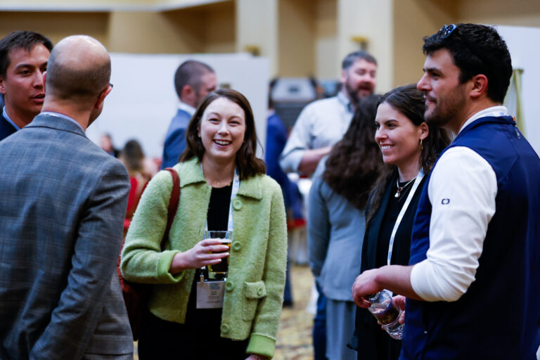 A group of people networking at Siting 2024