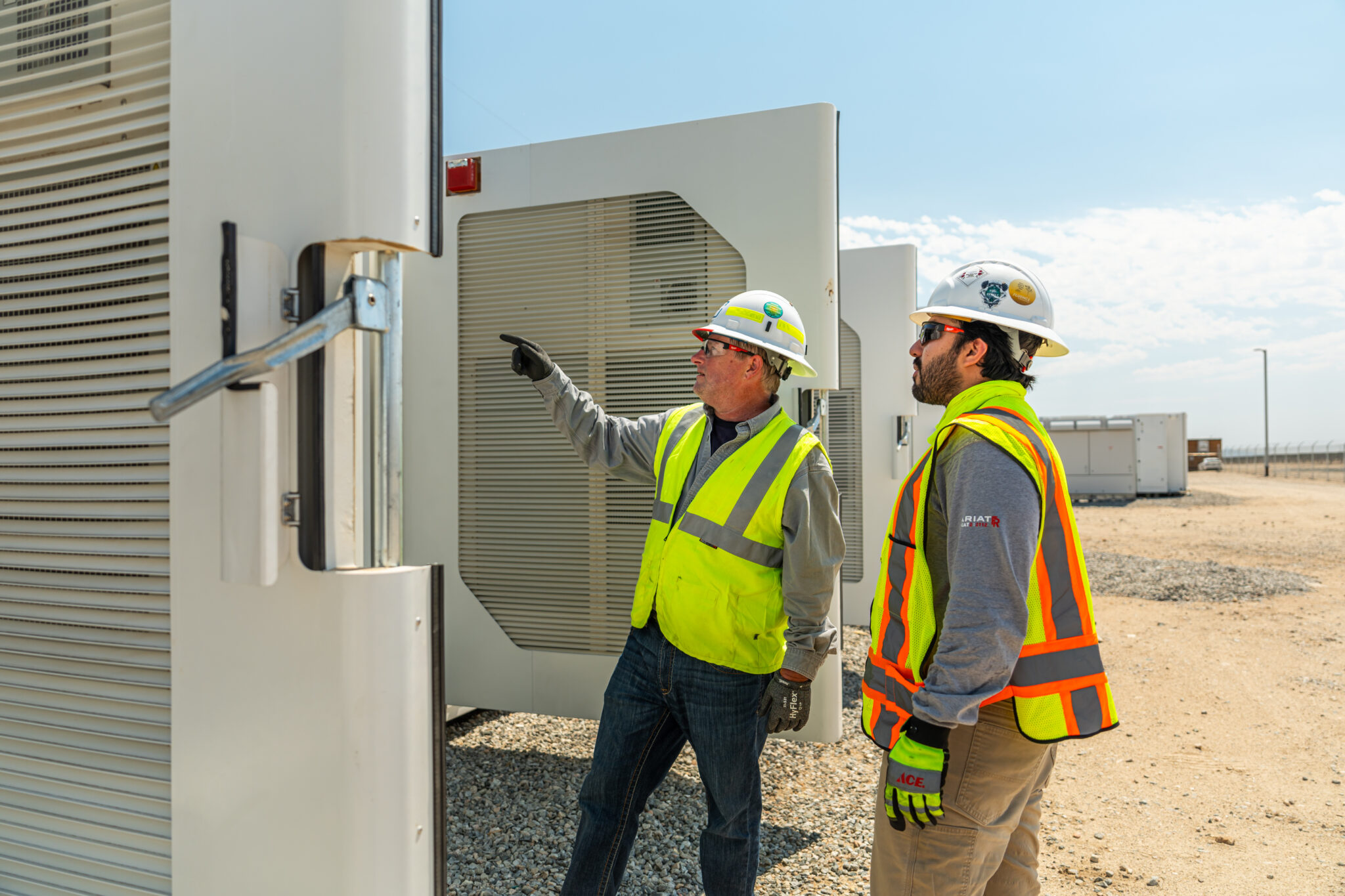 clean energy workers inspecting grid stack