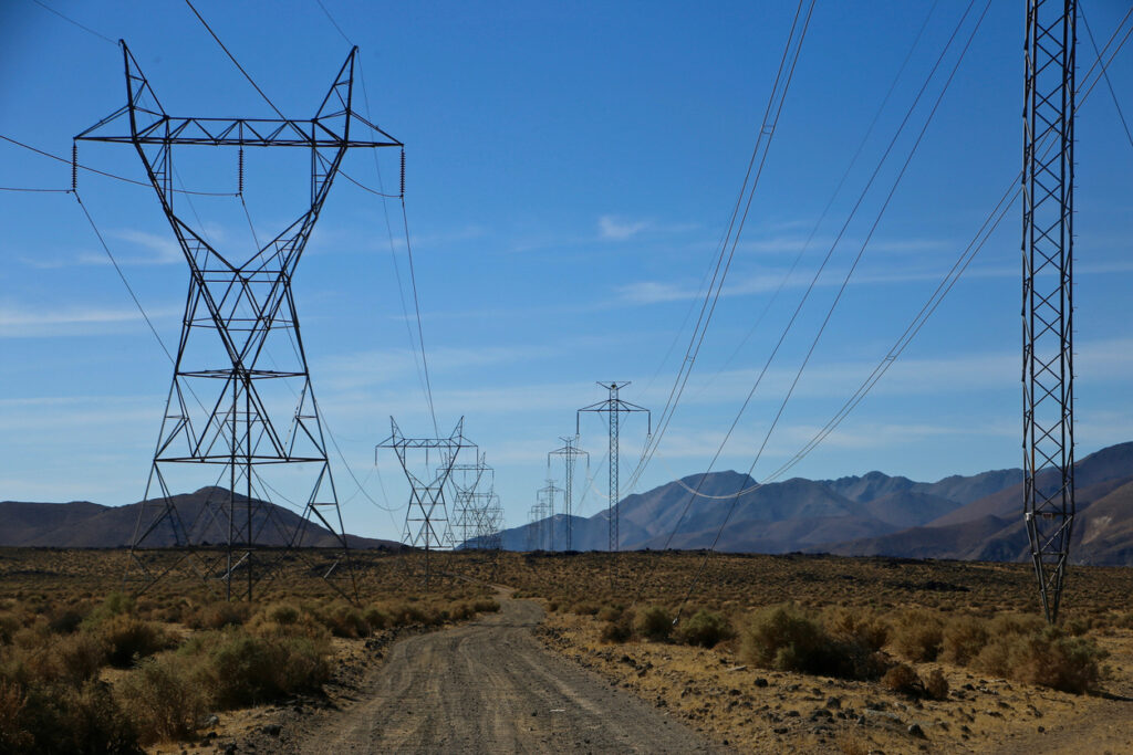 Transmission towers and power lines in the desert.