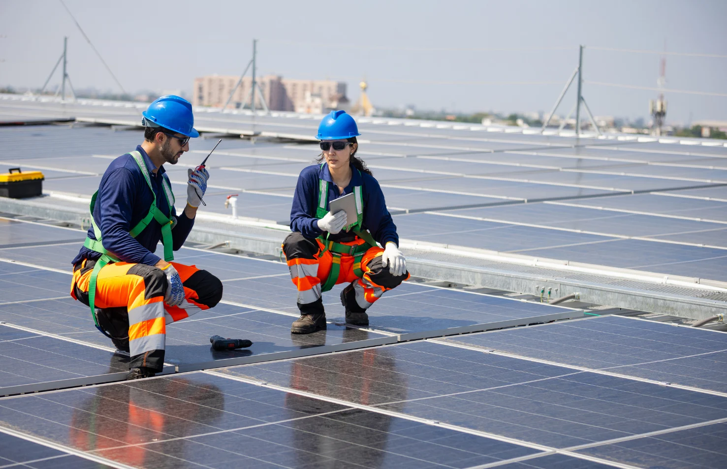 Construction Workers Discussing with Solar Panels